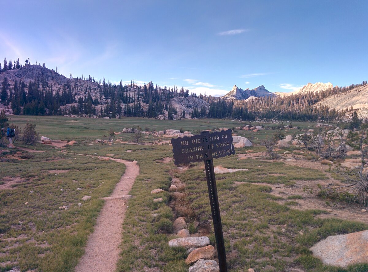 JMT meadow with stock restrictions sign